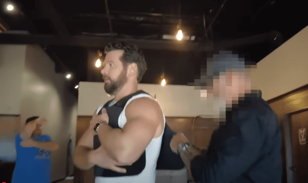 Steven Crowder fits a bullet proof vest before a "Change My Mind" public event in Dallas, Texas. Picture/YouTube